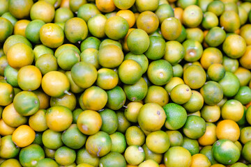 typical colombian fruits stacked in market place (orange)
