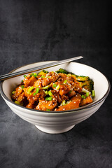 Delicious sweet chopping chicken rice, sesame seeds and sliced spring onions, broccoli, vegetables with chopsticks. Asian food, Japanese food copy space for your text