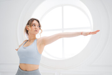 Fototapeta na wymiar Female fitness exercise workout female trainer. Yoga posture concentration balance and harmony