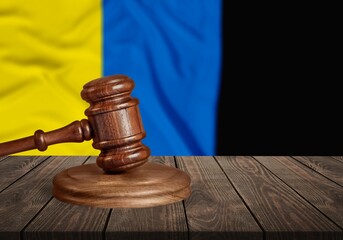 Judge's law gavel with flag of Ukraine on desk