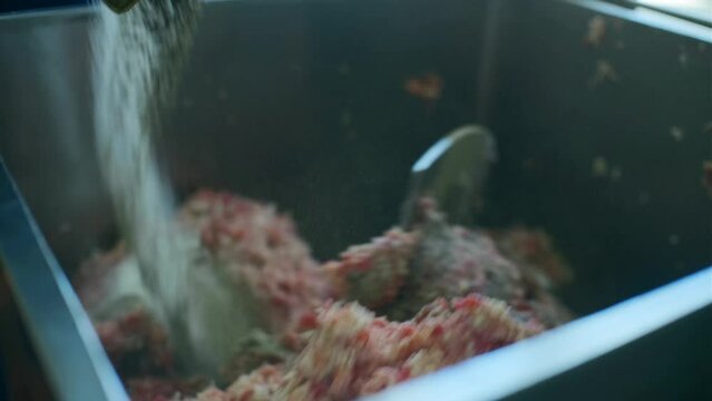 Mixing minced meat in production mixer. Clip. Mixture with minced meat is kneaded in large quantities in production. Food production