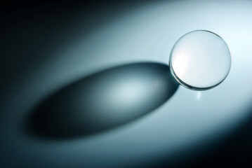 Composition with glass ball and shadow. Transparent ball with selective focus.
