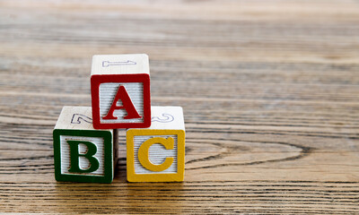A, B and C wooden alphabet blocks on the table