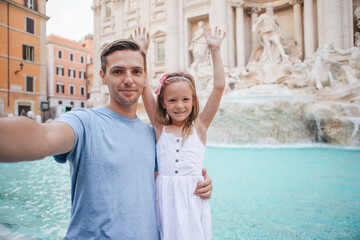Father and kids near Fontana di Trevi, Rome, Italy.