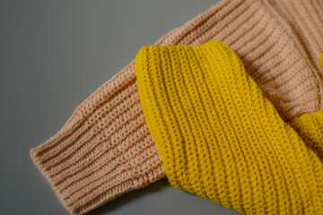 Various colors baby sweaters on dark gray background