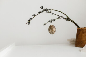 Happy Easter! Easter rustic minimalist still life. Natural easter eggs hanging on willow branches...