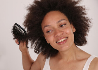 How to detangle and brush Afro hair. Hair care concept.