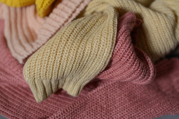 Various colors baby sweaters on dark gray background