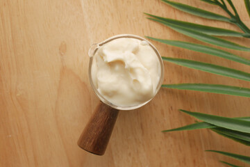 close up of Mayonnaise in container on table .