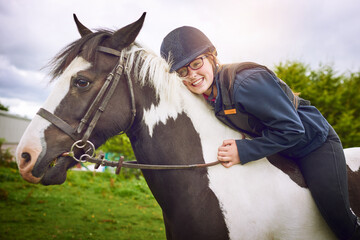 No one makes her as happy as her horse. Shot of a teenage girl going horseback riding on a ranch.