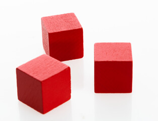 Three red wooden blocks on white background