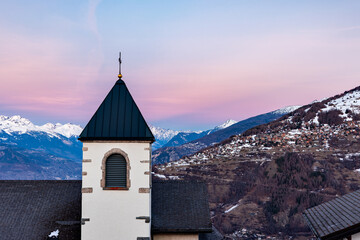 Beautiful historic church in small village at the Swiss alps during sunset, Nendaz Switzerland