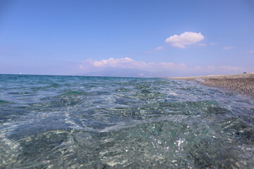 View from the beach.   Transparent morning sea, сalm, sea holiday Calabria Coast, Italy, Tyrrhenian Sea