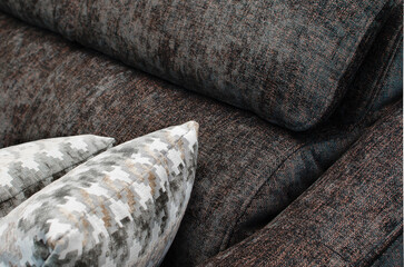 Close up detail of Brown pillow on sofa in a home.