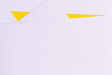 geometric background with light lavender papers and bright yellow triangles.