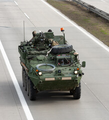 US army military convoy passes  in Czech Republic. Strykers, wheeled armored vehicle drives on...