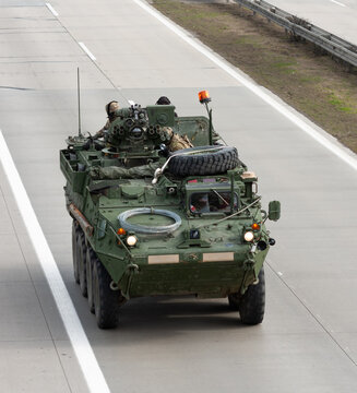 US army military convoy passes  in Czech Republic. Strykers, wheeled armored vehicle drives on highway .