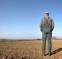 An farmer stands in his dry field on a glorious spring day and worries about the newly sown seed. Already in March it hardly rained and the fields have dried up. Climate change can be felt everywhere.