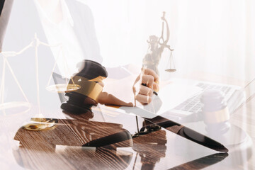 Justice and law concept. Gavel on sounding block in hand's Male judge at a courtroom, working with document law books, report the case on table in modern office.