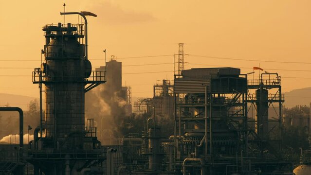 Petrochemical plant or oil and gas refinery industry with orange sky sunset background