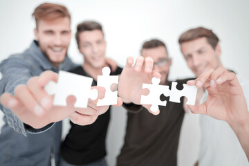 group of young people with puzzle pieces