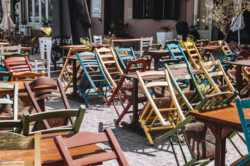 View of none opened caffe with colorful chairs in the morning - obrazy, fototapety, plakaty