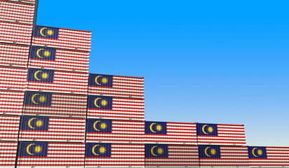 Containers with flag of Malaysia represent declining trend. Economic or export crisis concept. 3D rendering
