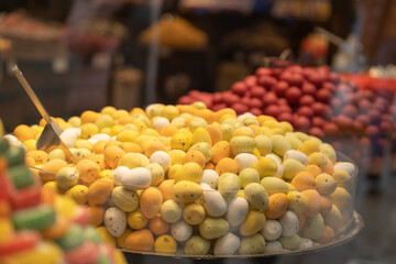 A lot of yellow colored candies in the form of Easter eggs on a shop window in the market