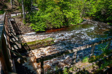 Ruins of Nommeveski hydroelectric station. Spring landscape with a fast river. Nõmmeveski, Estonia.