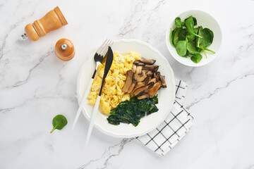 Omelet. Spinach oyster mushroom and cheese omelet or frittata on white marble background. Breakfast...