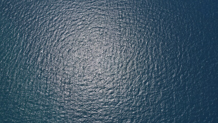 Blue sea surface from above, Aerial view of blue Ocean with waves from a high angle © naraichal