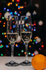 Two glasses of champagne on the background of festive Christmas lights. Glass for wine. bokeh. Christmas. New Year