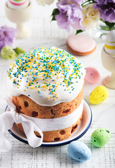 Traditional Easter sweet bread or cakes with white icing and sugar decor and quail eggs over white wooden table. Various Spring Easter cakes. Happy Easter day. Christian traditions.  Top view.