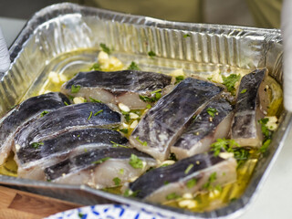 Closeup shot of an aluminum foil tray with fish slices