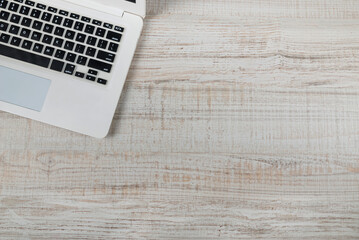 top view of laptop on wooden background