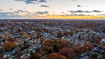 Aerial view over Long Island in New York at sunset during fall time and showing fall foliage