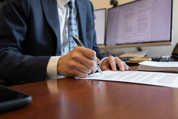 Businessman signing a document in the office