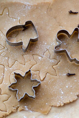 Rolled ginger dough on the table with Christmas cookie cutters. Silhouettes on the test. Christmas Cookies viewed from above