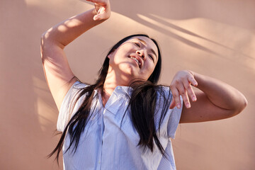 woman leaning back with hands extended 