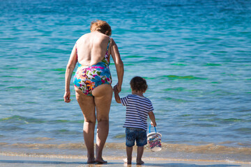grandmother with grandson enjoying on the beach
