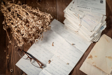 Old letters, eyeglasses and dried flowers. Vintage, sepia. Nostalgic Reading
