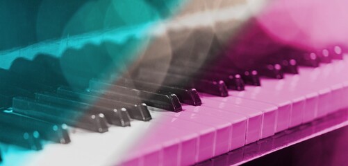 Keys classic piano keyboard in pink and blue neon lights colors.