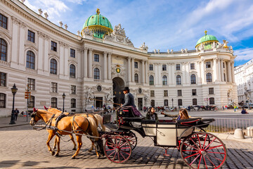 Horse carriage at Hofburg palace on St. Michael square (Michaelerplatz), Vienna, Austria 