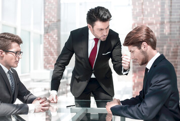 annoyed businessman scolds his employees