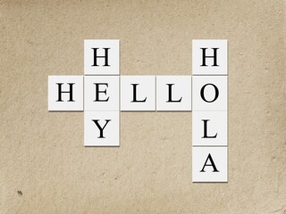 Hey Hola Hello letters, tiles against abstract background. © BillionPhotos.com