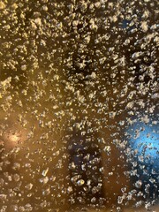 Frozen drops on the window, iced drops on the dark background