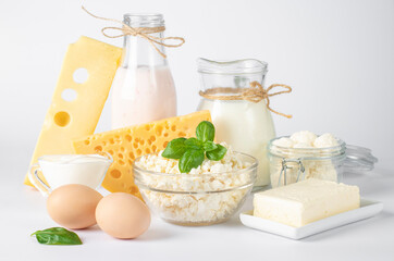 Dairy products, Milk, Yogurt, Sour Cream, Assorted Cheese, Cottage Cheese, Butter and Eggs on white background