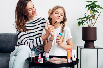 Mother and daughter wearing perfume