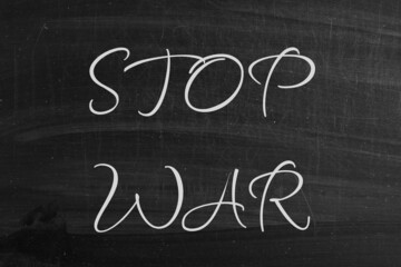 Stop war, handwritten on black schoolboard