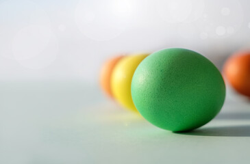 Easter eggs on blue background close-up, copy space